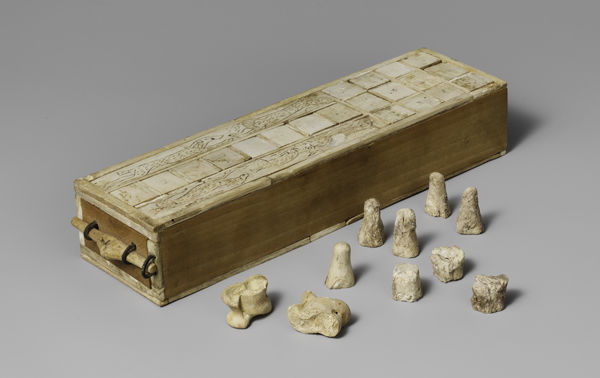 Double-sided game box with playing pieces and a pair of knucklebones. Thebes, Egypt. ca. 1635-1458 B.C. The Metropolitan Museum of Art, Rogers Fund, 1916 (16.10.475a)
