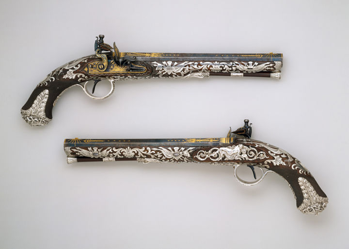 Two silver decorated pistols