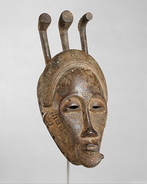 Portrait face mask from a mblo performance, Baule artist Baoulé, Wood, pigment, iron, Baule